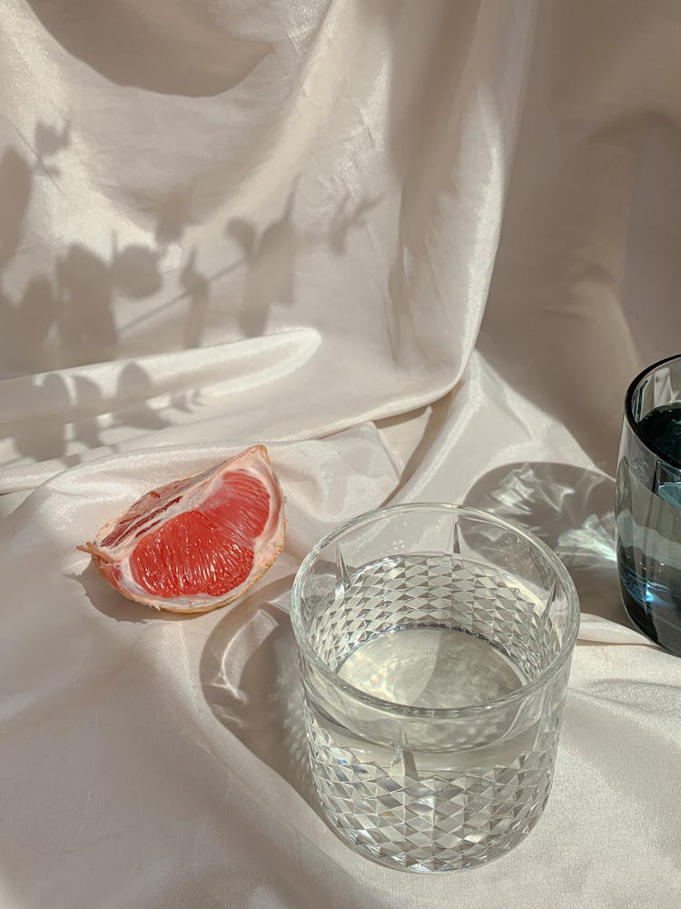 A Wedge Of Grapefruit And A Cup Of Water