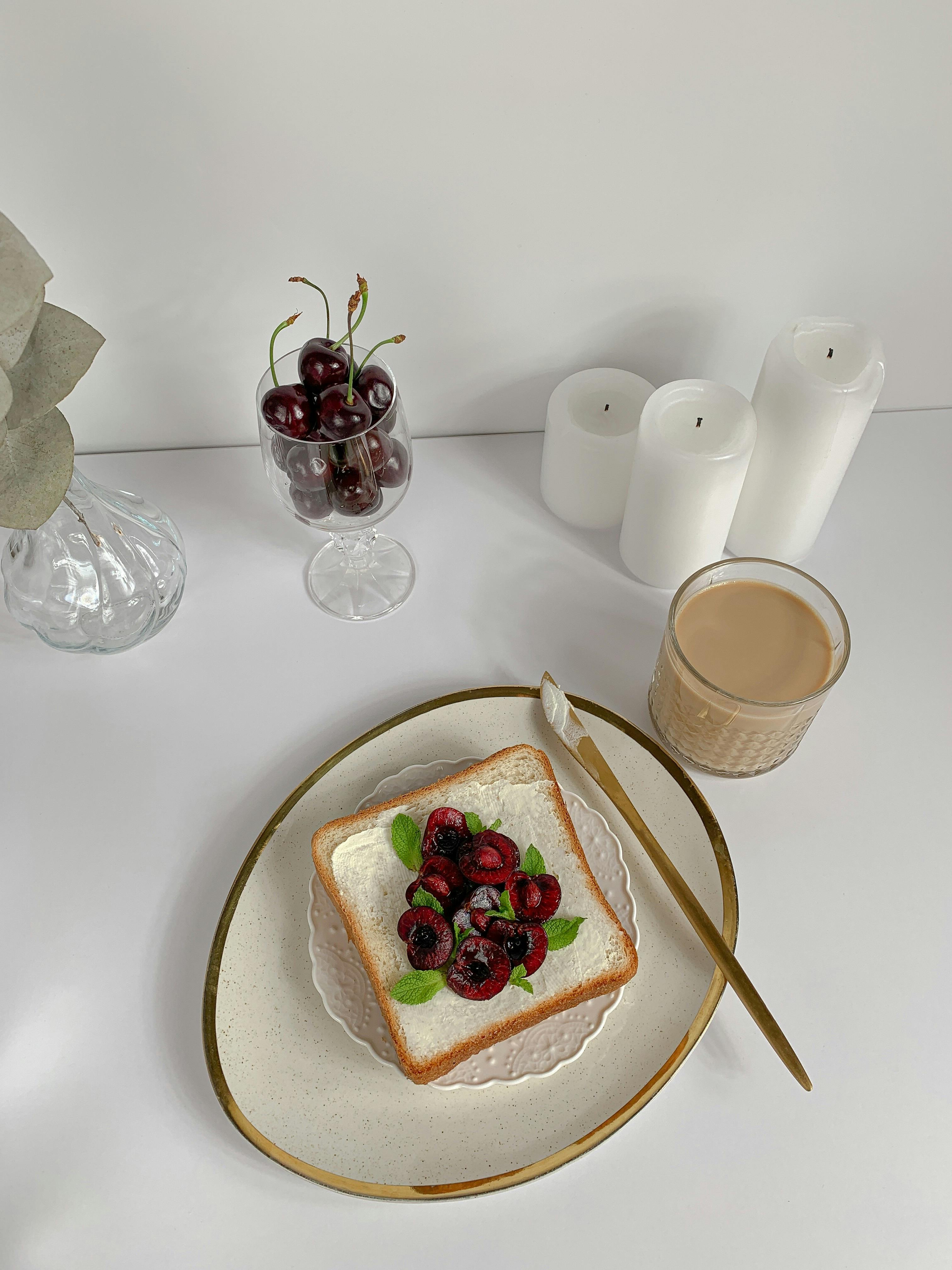 bread with cherries on a white plate