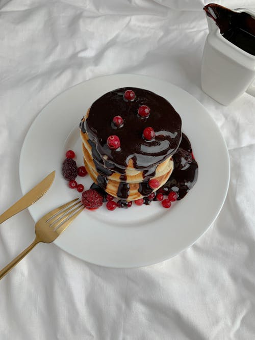 A Stack of Pancakes With Chocolate Syrup 