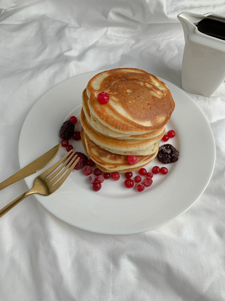 Close-Up Shot Of Stack Of Pancakes On A White Plate