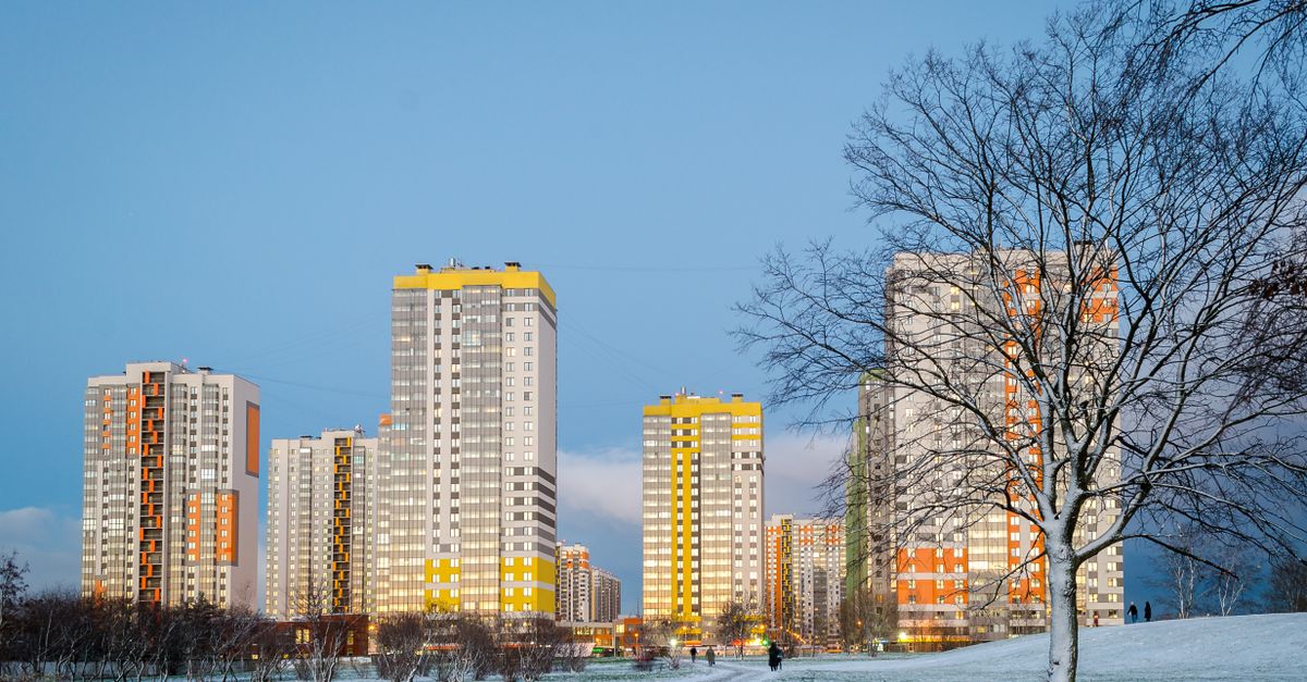 Contemporary skyscrapers in a snowy urban park at dusk, showcasing a modern cityscape.