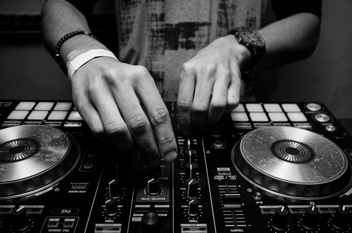 Free Grayscale Photography of Person Using Dj Controller Stock Photo