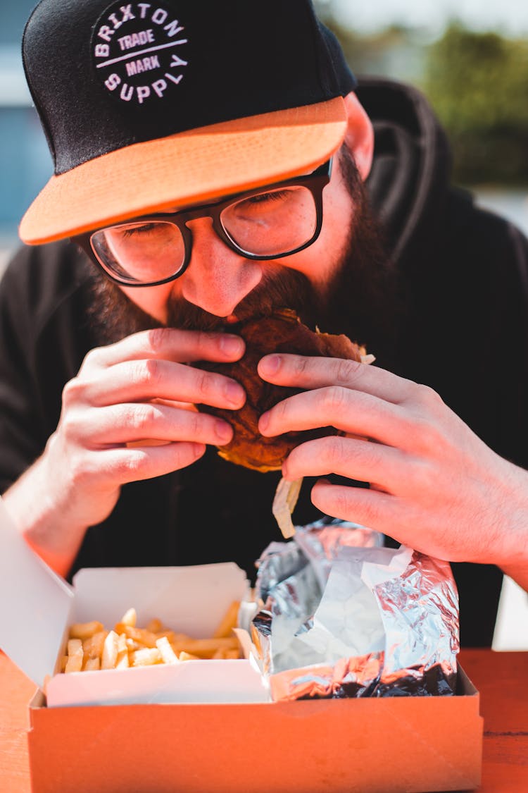 Close Up Photo Of A Man Eating Burger
