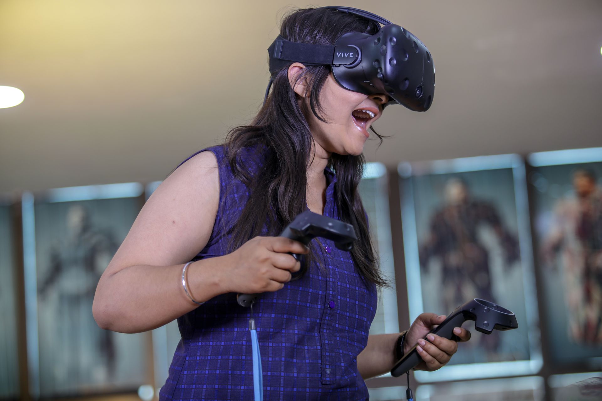 South Asian woman immersed in virtual reality gaming wearing a VR headset indoors.
