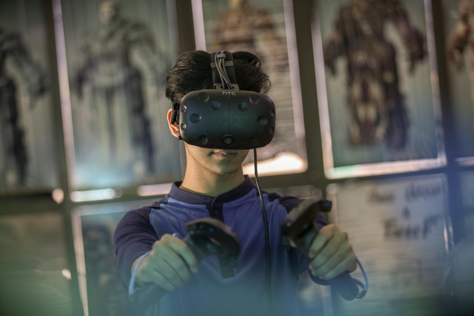 A young man using a VR headset and controllers for an immersive gaming experience indoors.