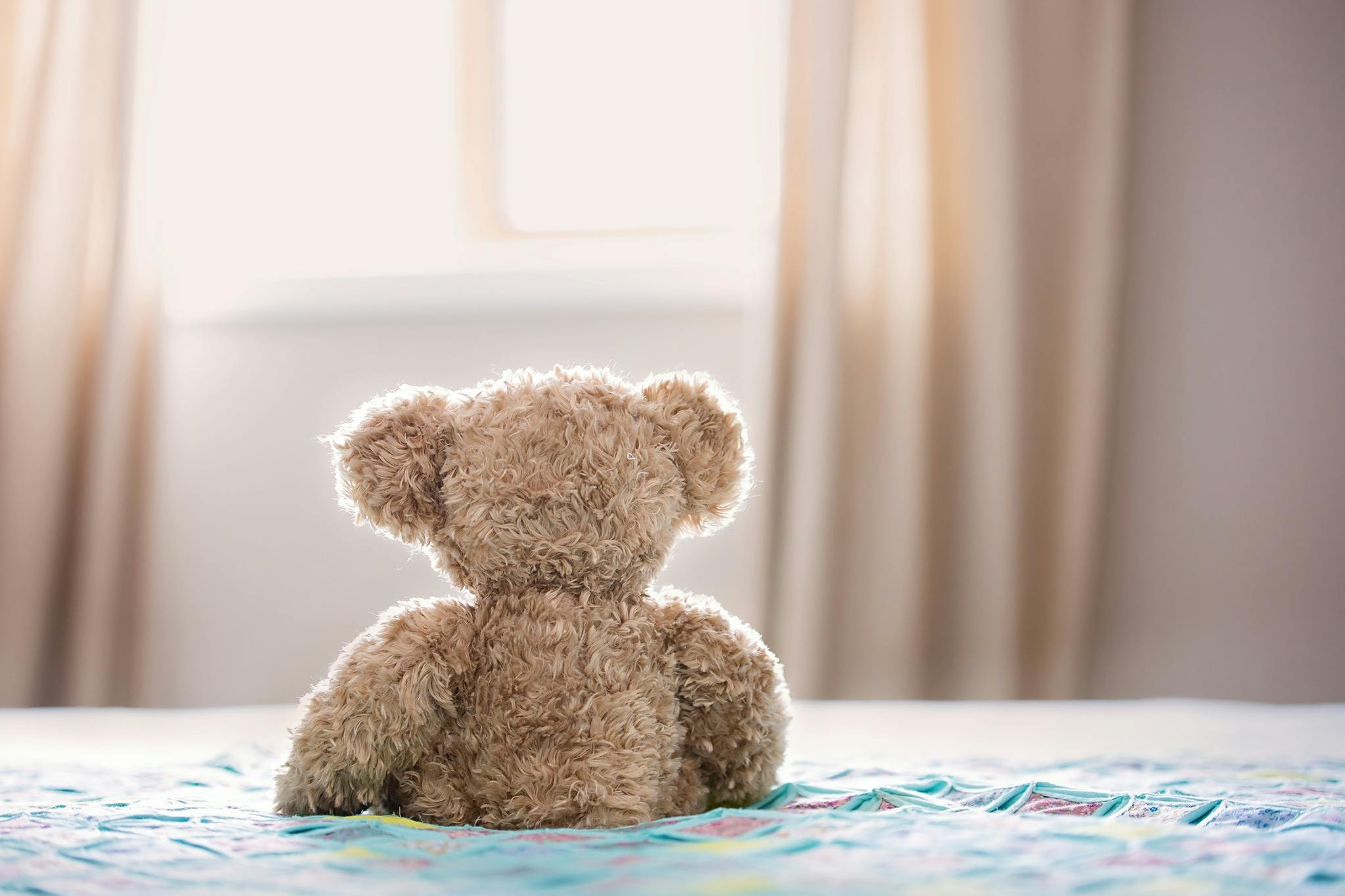 Brown Bear Plush Toy On Bed Free Stock Photo