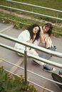 Woman in White Dress Shirt and Black and White Converse All Star High Top Sneakers
