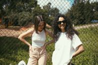 Friends Standing by the Chain Link Fence