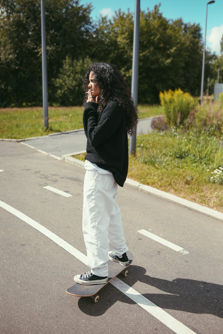 Woman Skateboarding While Smoking A Cigarette