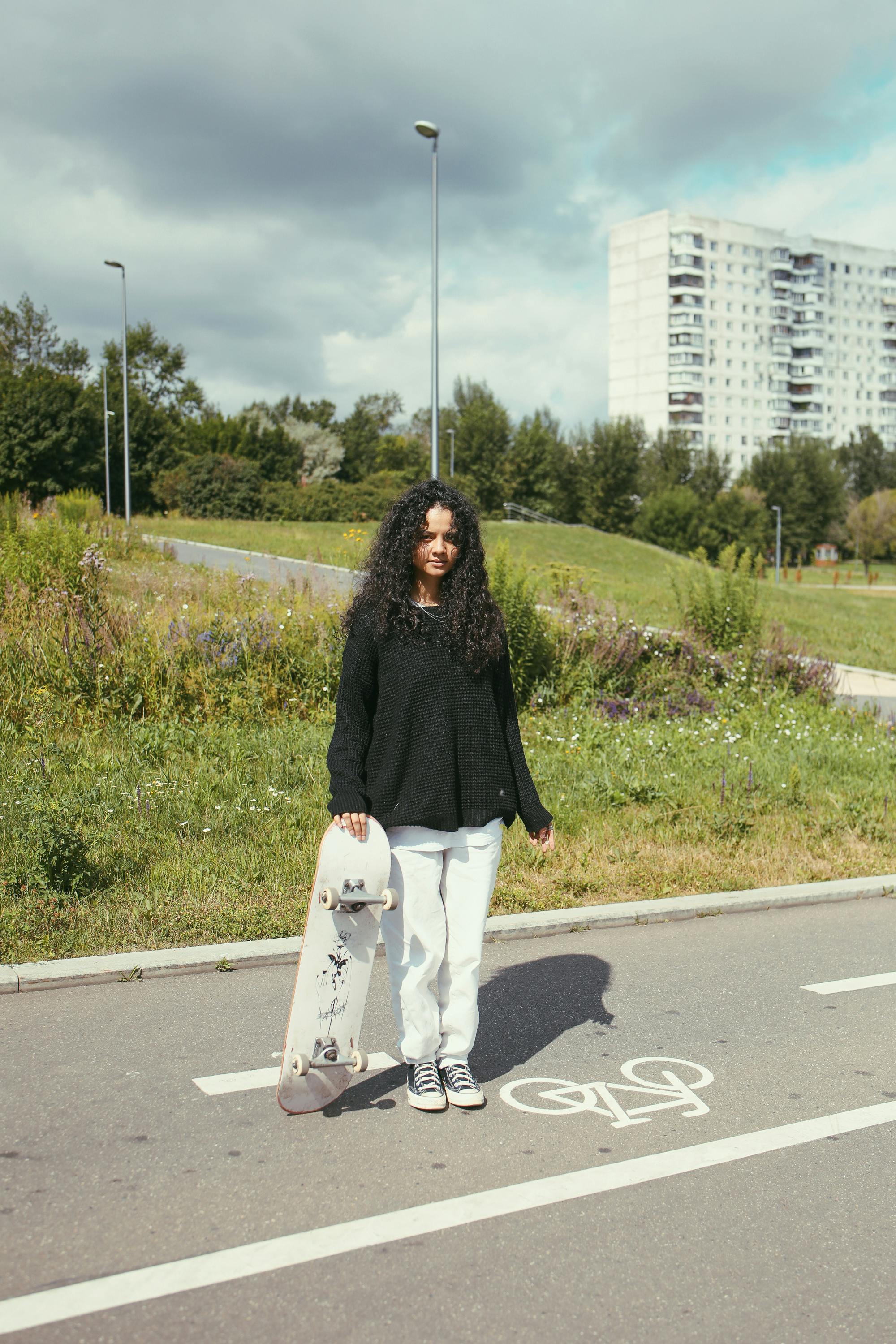 woman standing while holding a skateboard