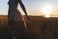 A Woman in Floral Dress Standing on the Grass