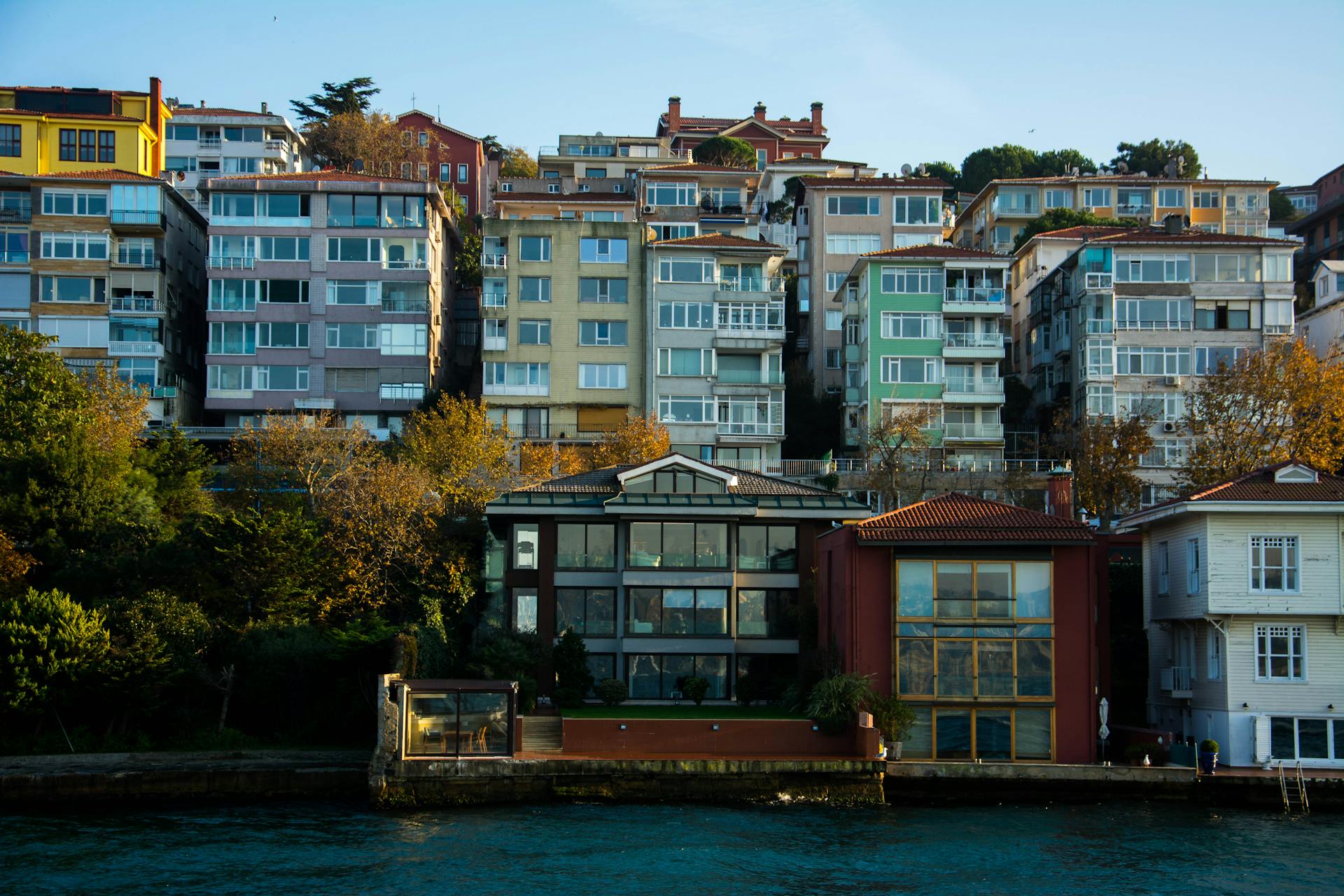 Series of Houses with Glass Walls and Windows Close to the Waterfront