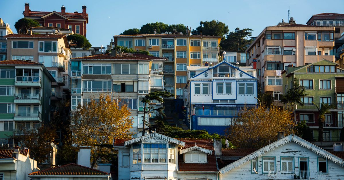 Urban scene featuring diverse architecture with colorful apartment buildings under a blue sky.