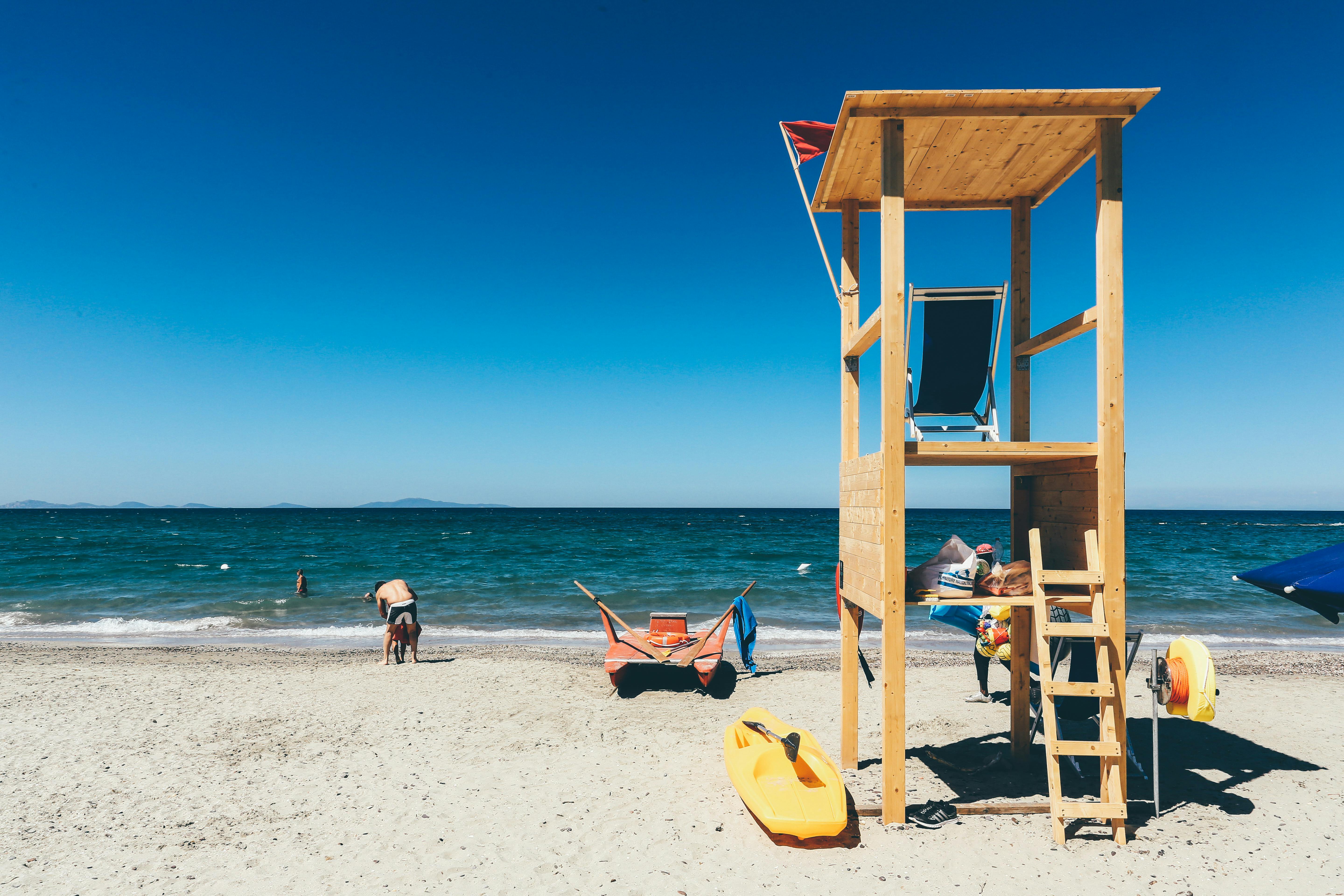 Red and Blue Striped Shed on Sand · Free Stock Photo