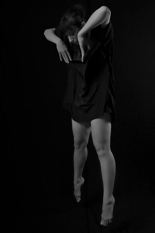 A Woman Wearing Black Clothes Doing a  Contemporary Dance