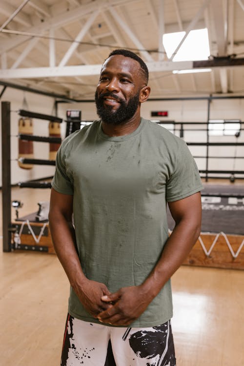 A Bearded Man in Gray Crew Neck T-shirt Standing with Hands Together