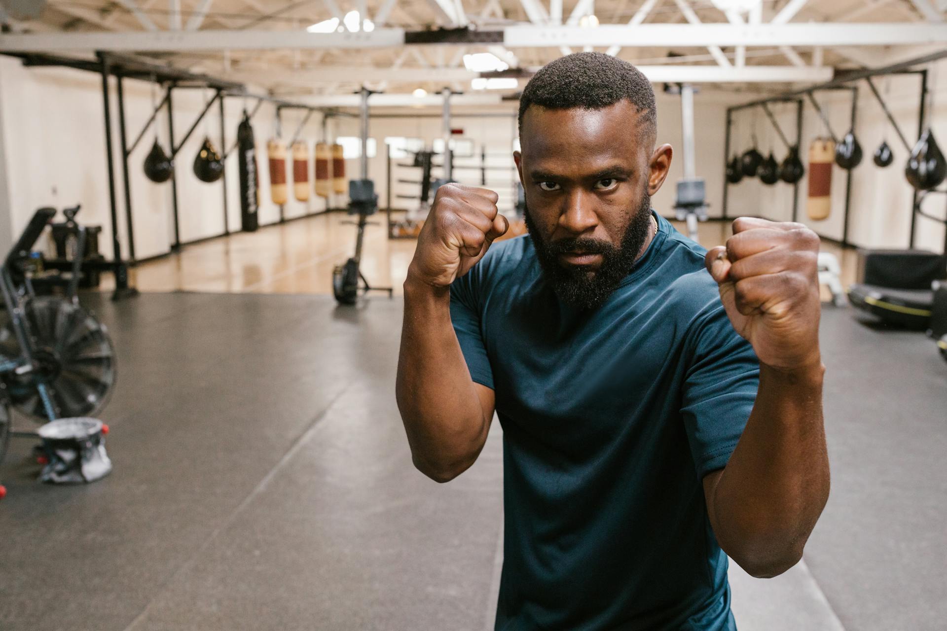 A Man in Blue Shirt Training for Boxing