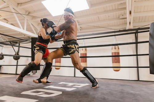 A Man and a Woman Inside the Boxing Ring