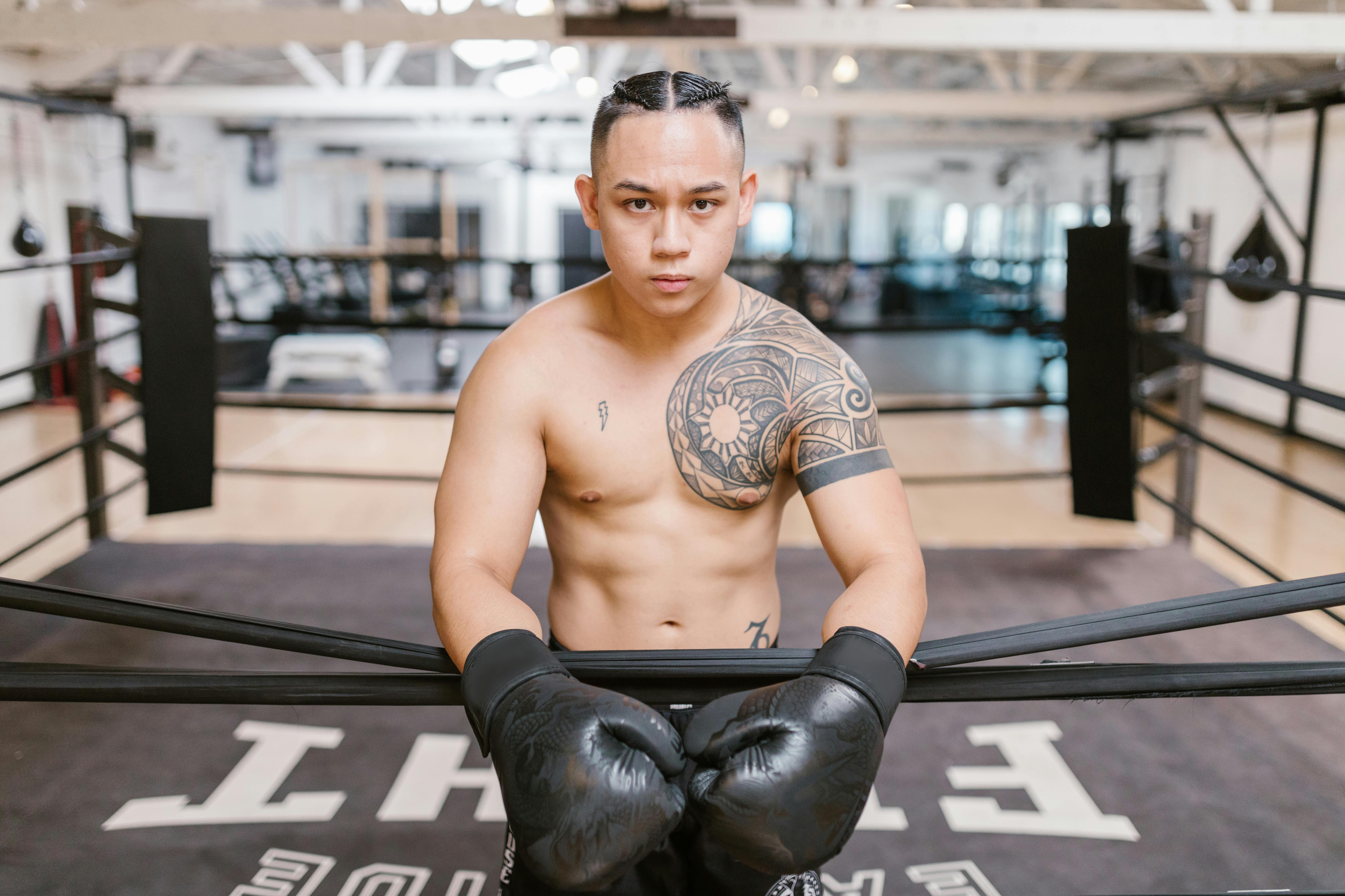 A Topless Man Standing on a Boxing Ring · Free Stock Photo