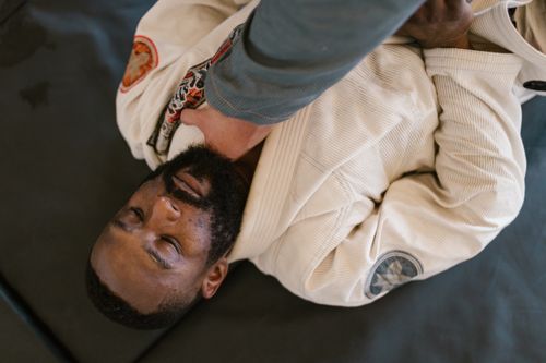 Free Martial arts practitioners in action during a grappling training session on the mat. Stock Photo