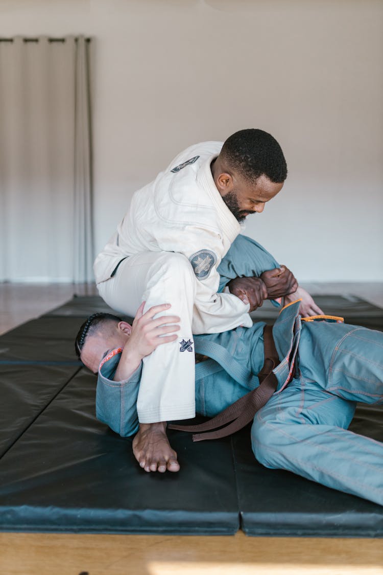 A Pair Of Taekwondo Athletes Sparring 