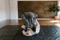 Man in Gray Uniform Standing on Black Mattress