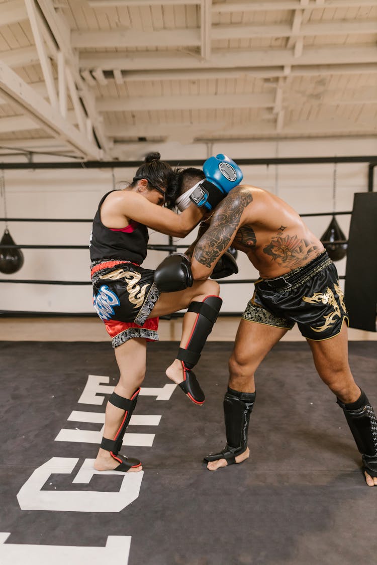 A Man And A Woman Doing Boxing Training