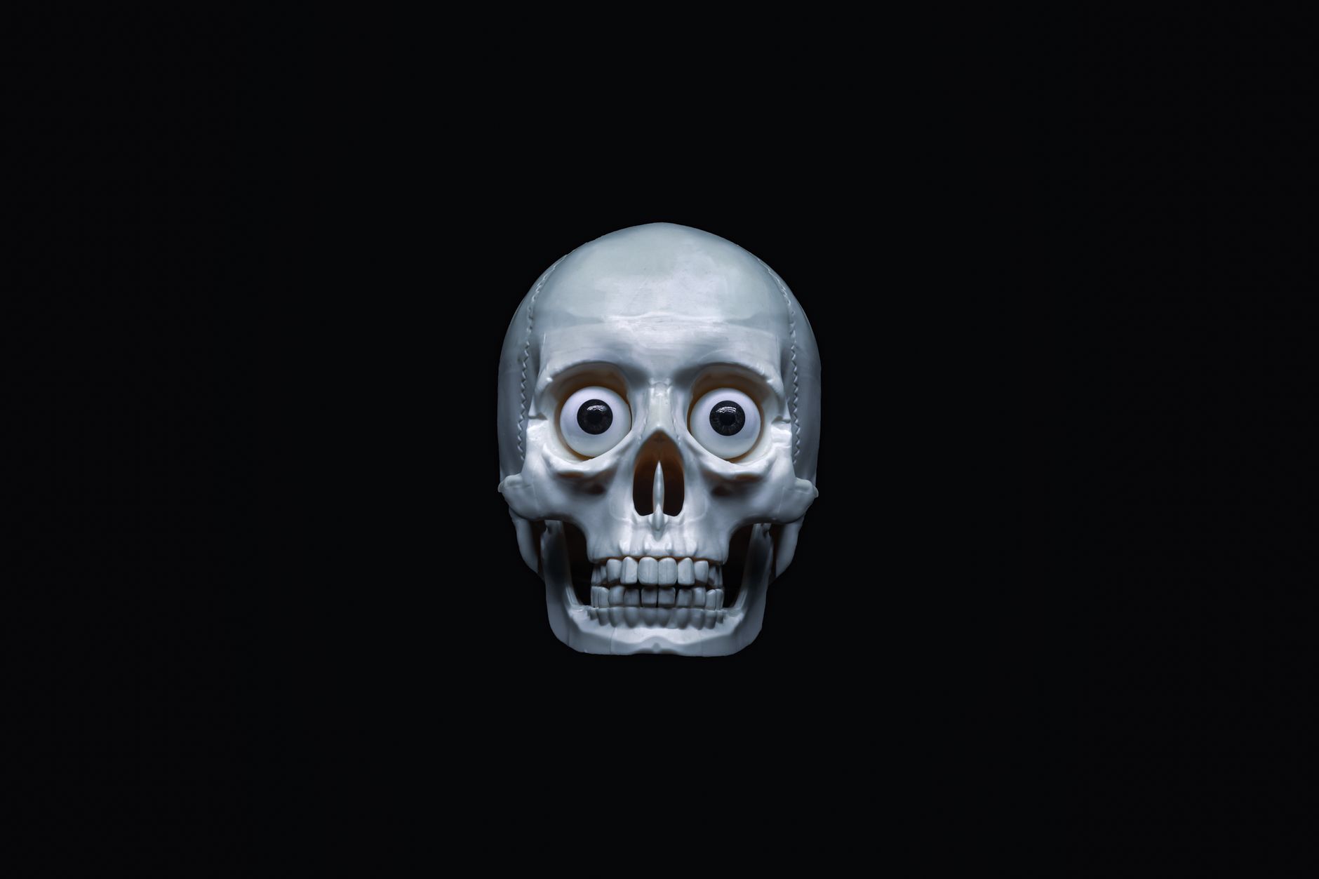 A spooky skull with googly eyes, ideal for Halloween themes and creepy art projects.