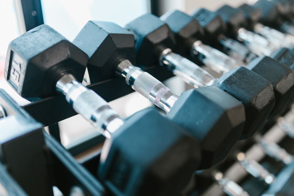 close-up on a dumbbell rack highlighting high-touch areas - fitness center cleaning services close-up on a dumbbell rack highlighting high-touch areas - fitness center cleaning services