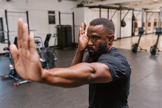 A determined martial artist practicing self-defense techniques in a modern gym.