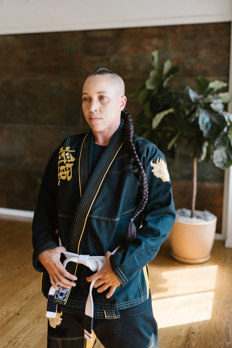 Woman With Braided Hair Wearing A Black Karate Uniform