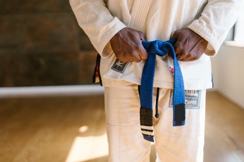 Person in a White Karate Uniform with a Blue Belt