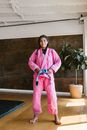 Woman in Pink Blazer and Pink Pants Standing on Blue Yoga Mat