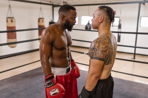 Free Two boxers face each other intensely in a boxing ring, showcasing strength and determination. Stock Photo
