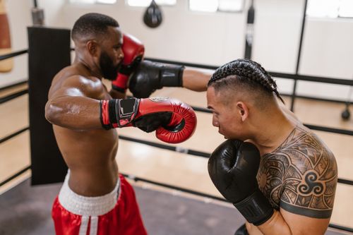 Free Two boxers in action during a training session in the boxing ring, showcasing strength and skill. Stock Photo