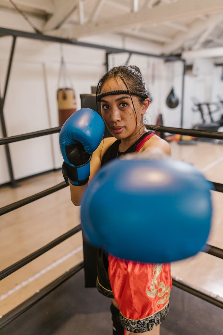 Woman Wearing Blue Boxing Gloves 