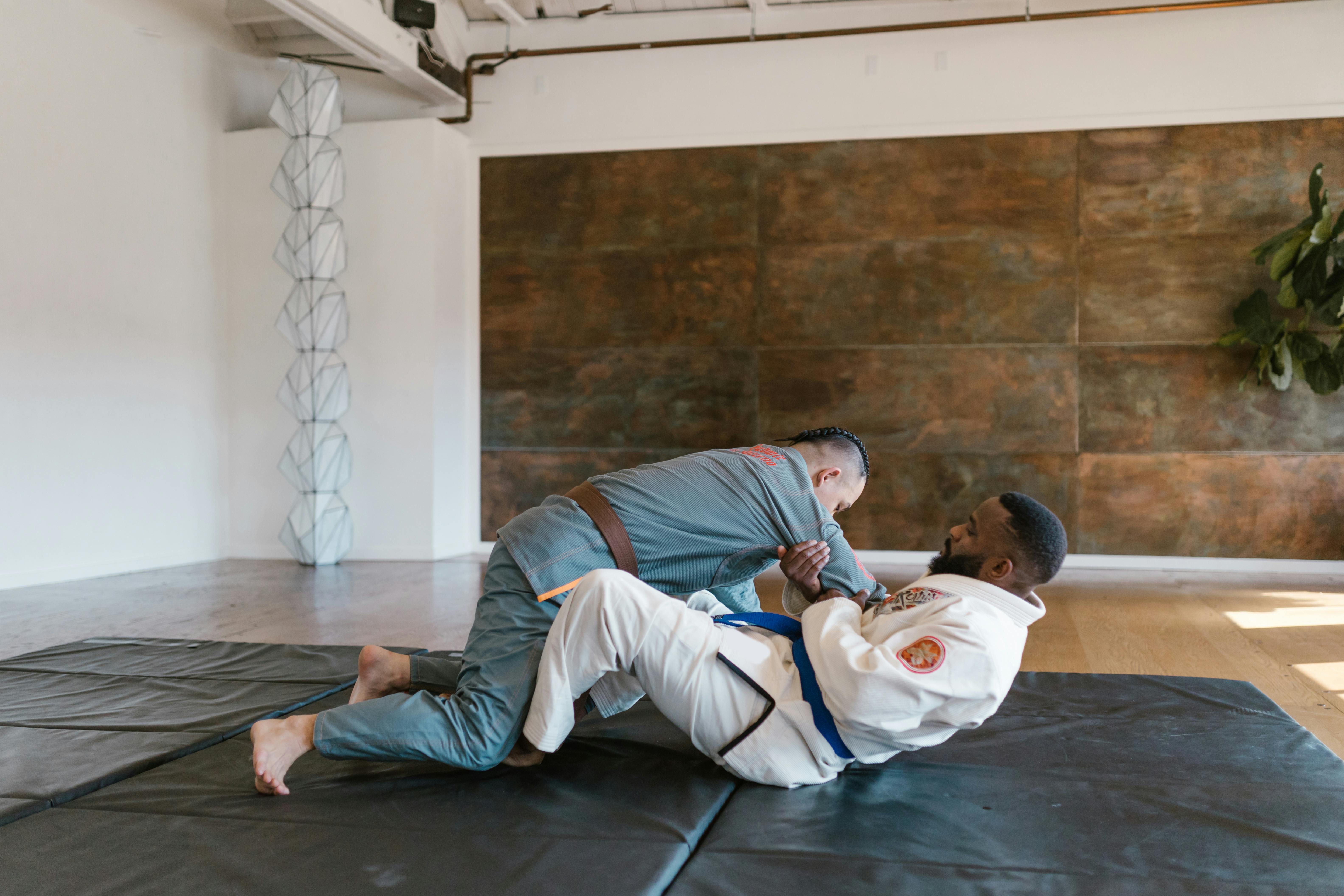 two men in karate uniform sparring