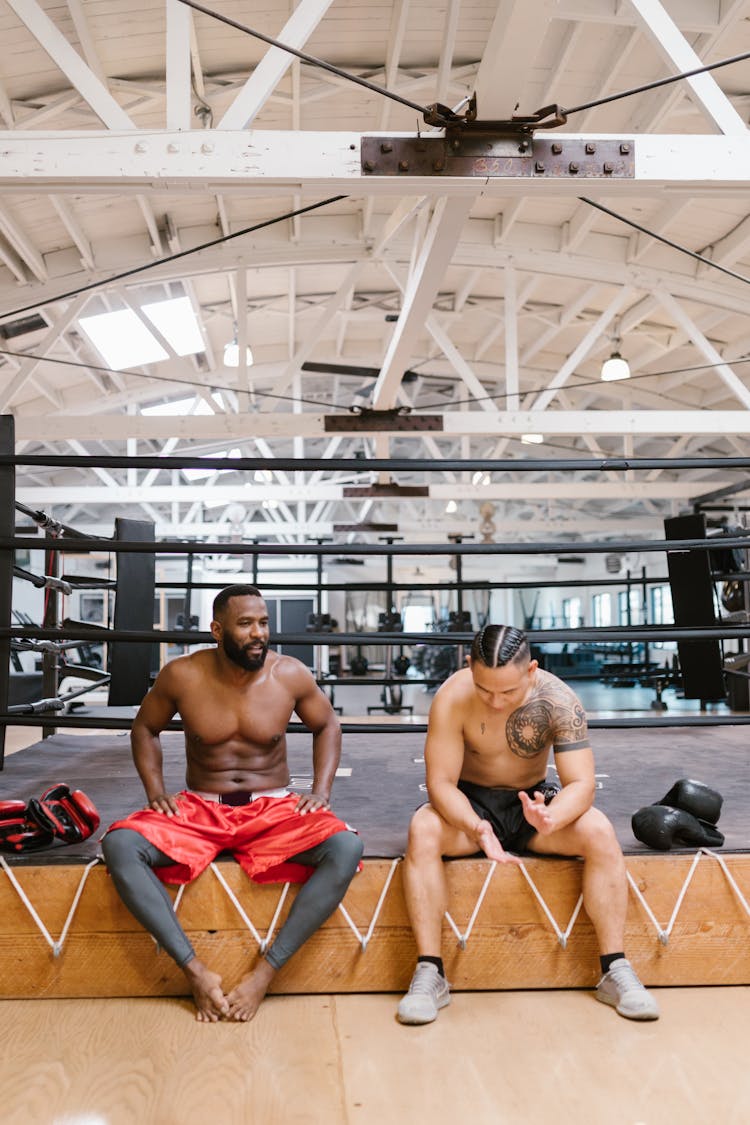 Men Resting Beside A Boxing Ring 