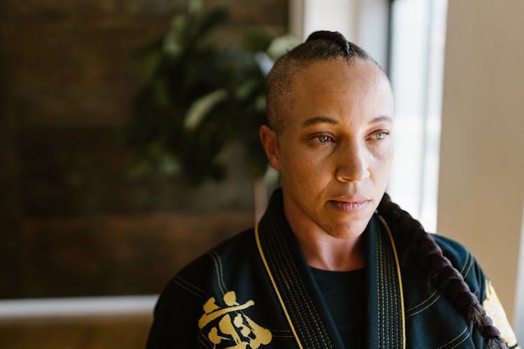 A Woman With A Braided Hair Wearing A Gi