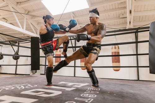 Free Two athletes practicing martial arts in a ring, showcasing powerful techniques. Stock Photo
