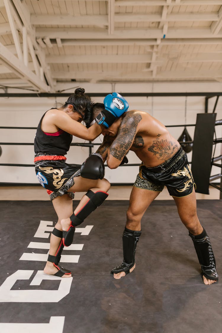 A Man And A Woman Training For Kickboxing