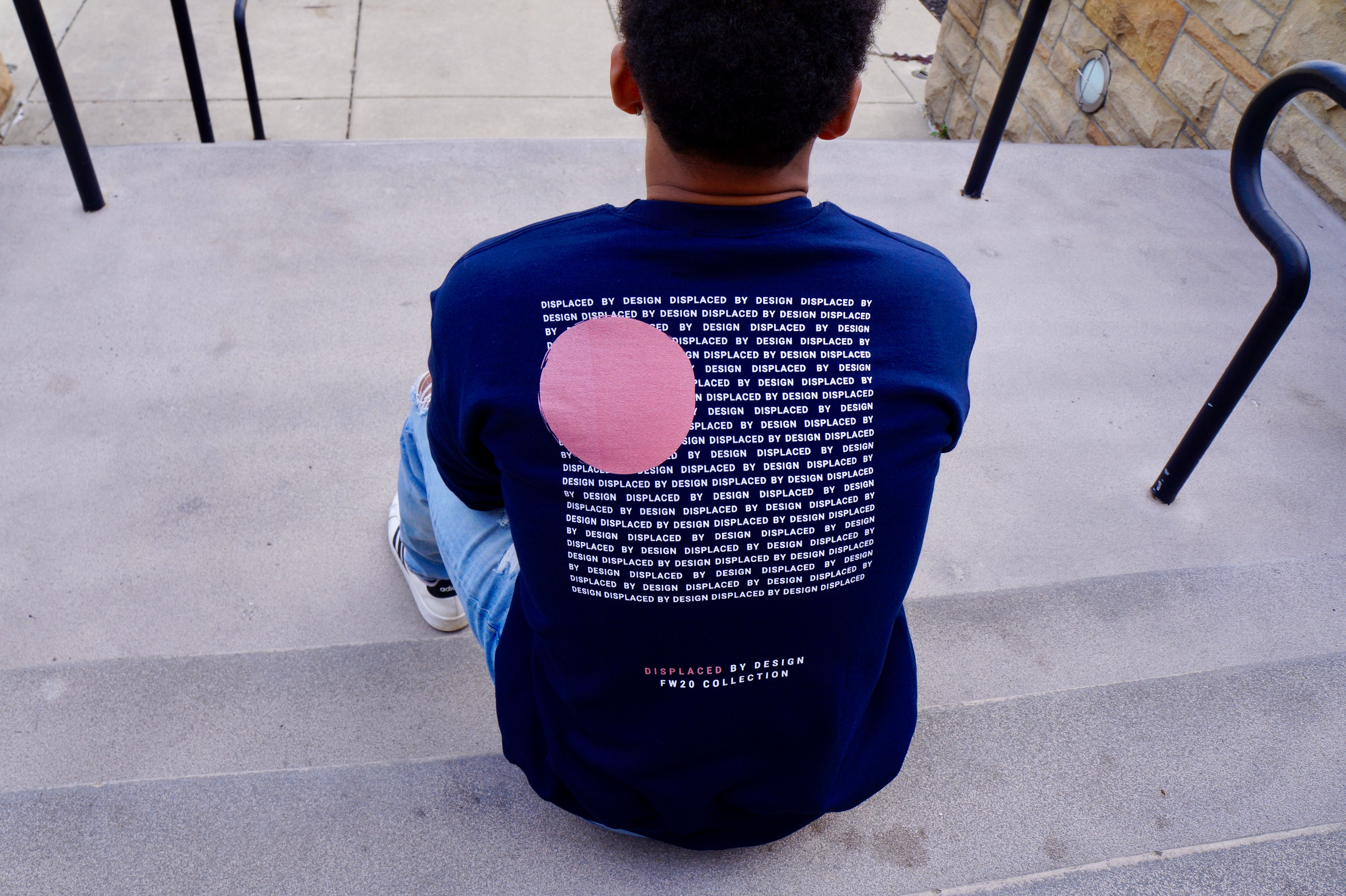 A curated collection of faith-inspired graphic t-shirts displayed on clean wooden hangars