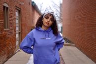 Girl in Blue Pullover Hoodie Standing on Sidewalk