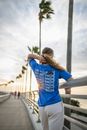Woman in Blue Shirt Standing Beside a Railing