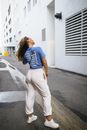 Woman in Blue Shirt Standing on the Street