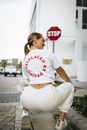 Woman in White Shirt Crouching