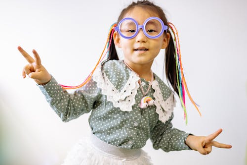 Pretty Girl in White and Gray Polka Dots Dress With Purple Framed Eyeglasses