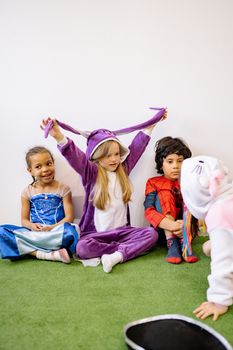 A group of children having fun in bright costumes, showcasing friendship and joy.