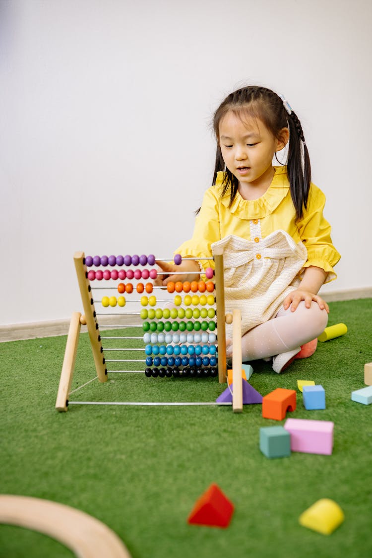 Pretty Girl Learning To Count With An Abacus