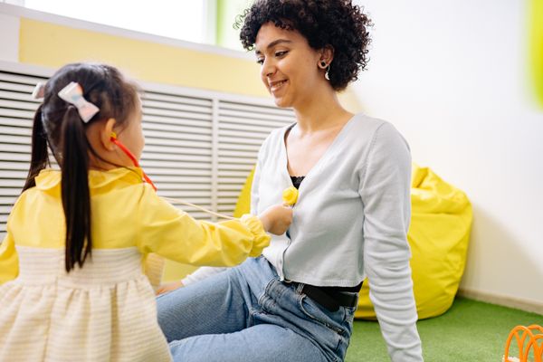 Children engaged in play-based therapy with colorful educational materials